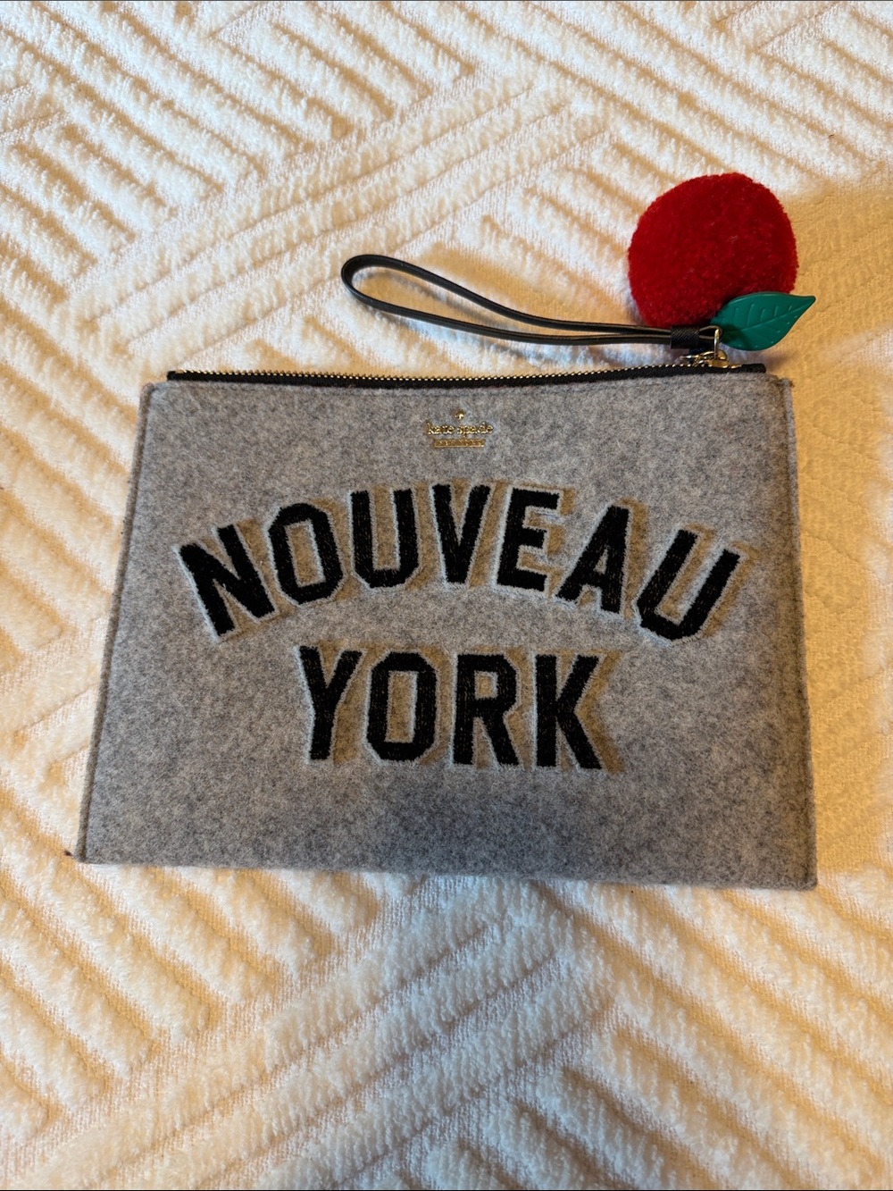 kate spade Gray Felt Wristlet with Red Pom Charm
